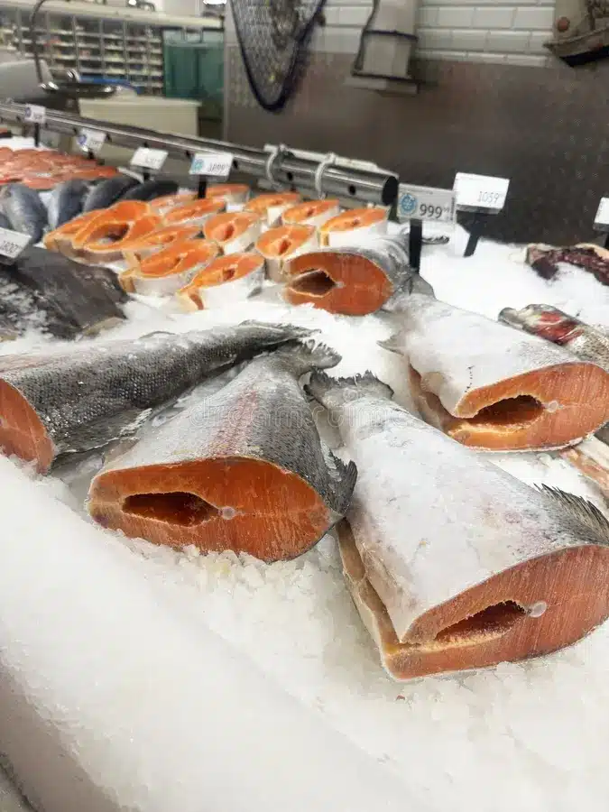 Fresh seafood displayed on ice at a fish market